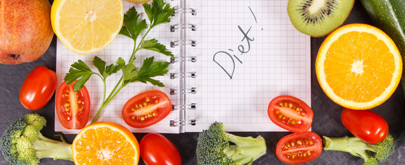 Word diet written in notepad and fruits with vegetables, healthy lifestyles concept