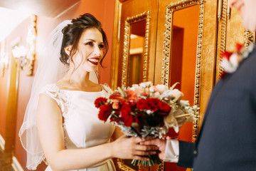 Meeting the newlyweds in the Studio and hotel. Bride and groom with a bouquet.