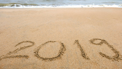 New year,2019 write on sand beach and ocean view, 2019 on the beach.