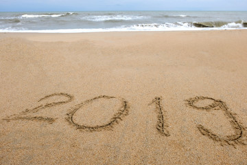 New year,2019 write on sand beach and ocean view, 2019 on the beach.