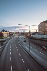 Cityscape view on highway right in the old town city center, classic Europe architecture. Cars on the road