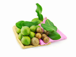 Group of macadamia in husk and in shell with gunnysack isolated on white background