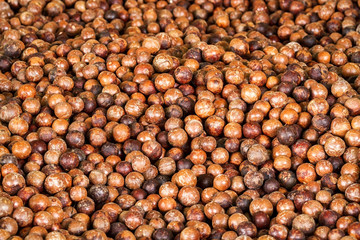 Close up a pile of macadamia in shell background