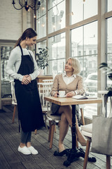 Mature woman having rest in cafeteria on the weekend