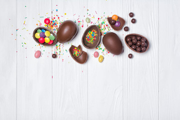 Chocolate traditional easter eggs with bright colorful dragee and sugar sprinkles or confetti
