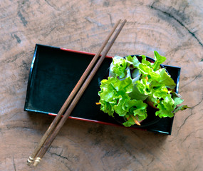 Vegetable salad in a black cup