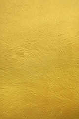 wall painted with gold color. textured background.