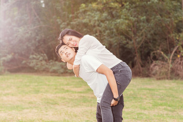 Happy young couple smiling and have fun at city park