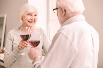 Amazing retired woman smiling to her partner