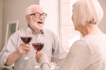 Positive delighted bearded man telling romantic story