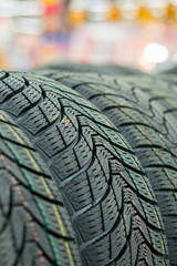 new tires for sale at booth in store. Winter Season Tire Tread. Brand New Car Tires on the Shelf....