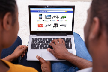 Couple Shopping Online On Laptop