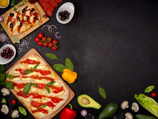 Delicious pizza with ingredients on black background. 