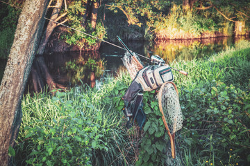 Fishing equipment on the bank of the spring river.