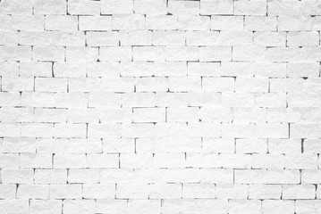 Old aged rough brick wall texture background painted in white color in grunge style