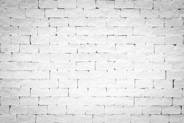 Old aged rough brick wall texture background painted in white color in grunge style
