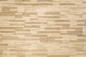 Brick tile wall pattern background in light yellow gold brown color