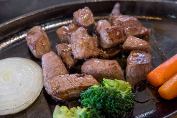 Medium rare meat on plate with sauce