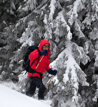 Hiker makes his way on snowy slope