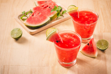 Close up of a glass of healthy watermelon juice with a wooden background.