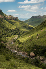 Fototapeta na wymiar Portrait view of the river gorge, cliffs and mountain sides on the Thukela hike to the bottom of the Amphitheatre's Tugela Falls in the Royal Natal National Park, Drakensberg, South Africa
