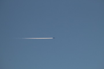 Aeroplane flying high in the sky with a contrail 