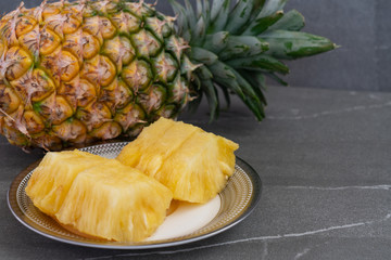Whole pineapple and pieces of pineapple.