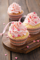 Pink Valentine's Day cupcakes decorated with candy.