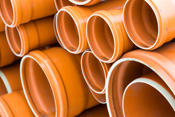 Orange sewage pipes close up shot for background, space for text.