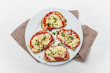 baked bread, crispy baked with salami, tomatoes and cheese