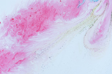 Abstract colorful background. Drawing with acrylic paints on water. Texture play of paint