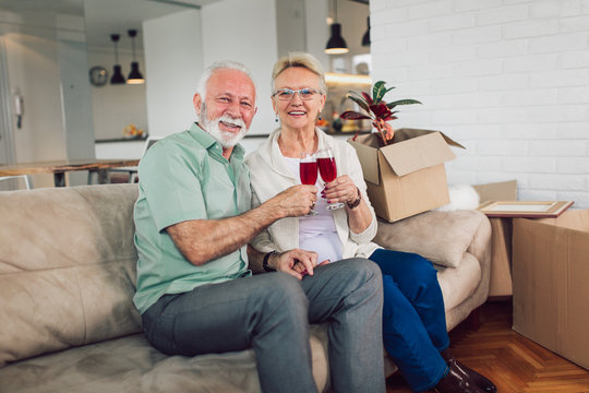 Cheerful Senior Couple Moving Into New Home