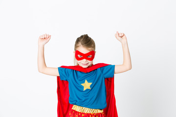 beautiful girl with red mask and supergirl outfit posing in front of white background