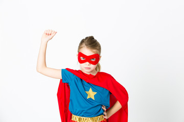 beautiful girl with red mask and supergirl outfit posing in front of white background