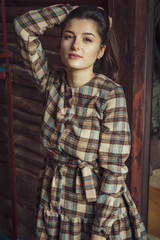 Portrait of a sexual young woman wearing checkered dress. Beautiful smart girl. Beauty, fashion of women wear showroom