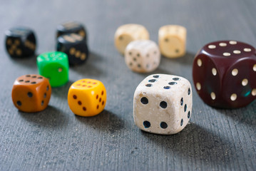 used dices with six dots on aged wooden background