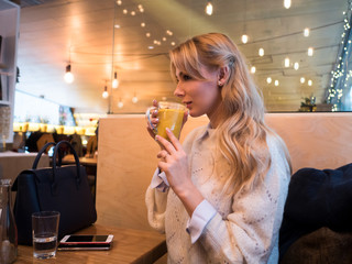 woman drinking cocktail in bar
