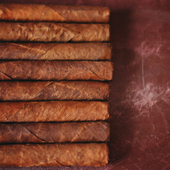 Luxury Cuban cigars on the wooden table.
