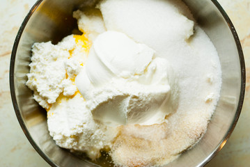 whipped cream topped dessert ingredients in metal mixing bowl