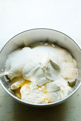 whipped cream topped dessert ingredients in metal mixing bowl