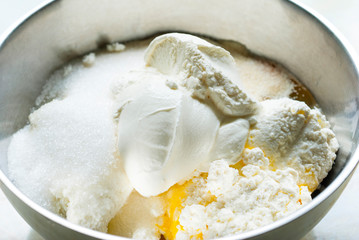 whipped cream topped dessert ingredients in metal mixing bowl