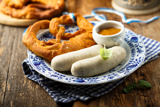 Traditional German pretzel with white sausage and mustard