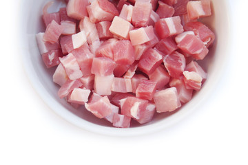 Fresh cubes of bacon in a bowl isolated on white background