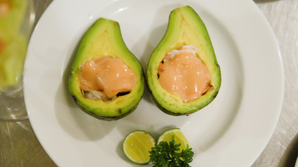 Avocado stuffed with shrimps and seafood. shrimp cocktail over open avocado