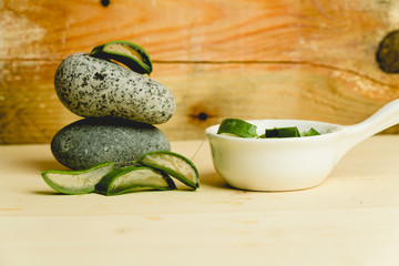 slices of fresh aloe on a calm, rustic, wooden background