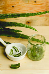 slices of fresh aloe on a calm, rustic, wooden background