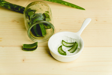 slices of fresh aloe on a calm, rustic, wooden background