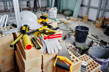 Home repairs. Construction tools, bricks and helmet