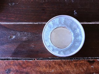 Top view of small silver bowl filled water on wooden table, prepare to pour water on the hands of revered elders and ask for blessing. Song kran day in Thailand