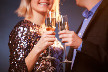 Image of couple with champagne glasses with champagne on black background